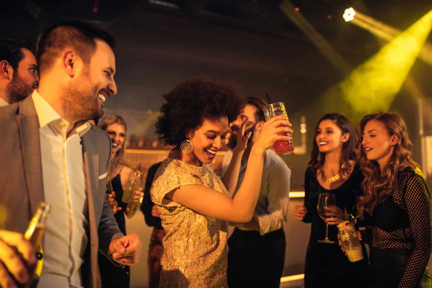 Group of young cheerful friends partying at a nightclub