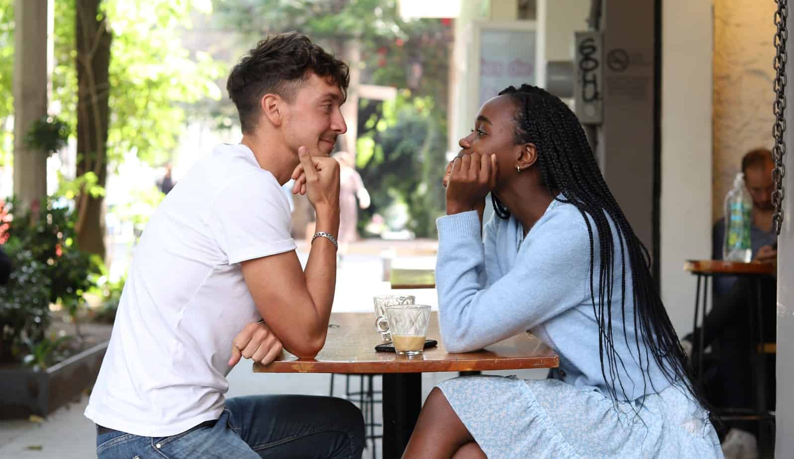 man and woman sitting at coffee shop on date