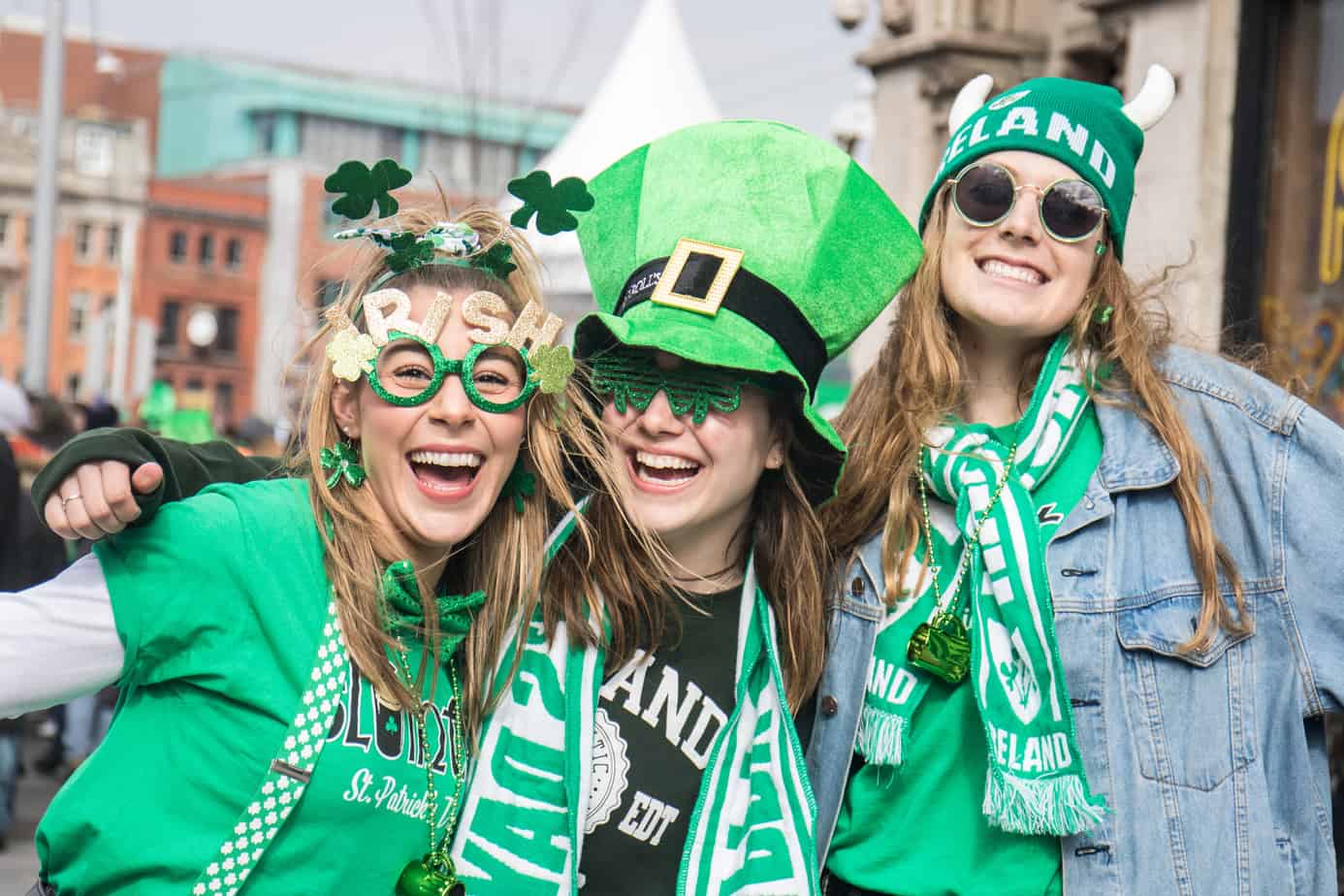 women dressed in festive green clothing celebrate st. patrick's day