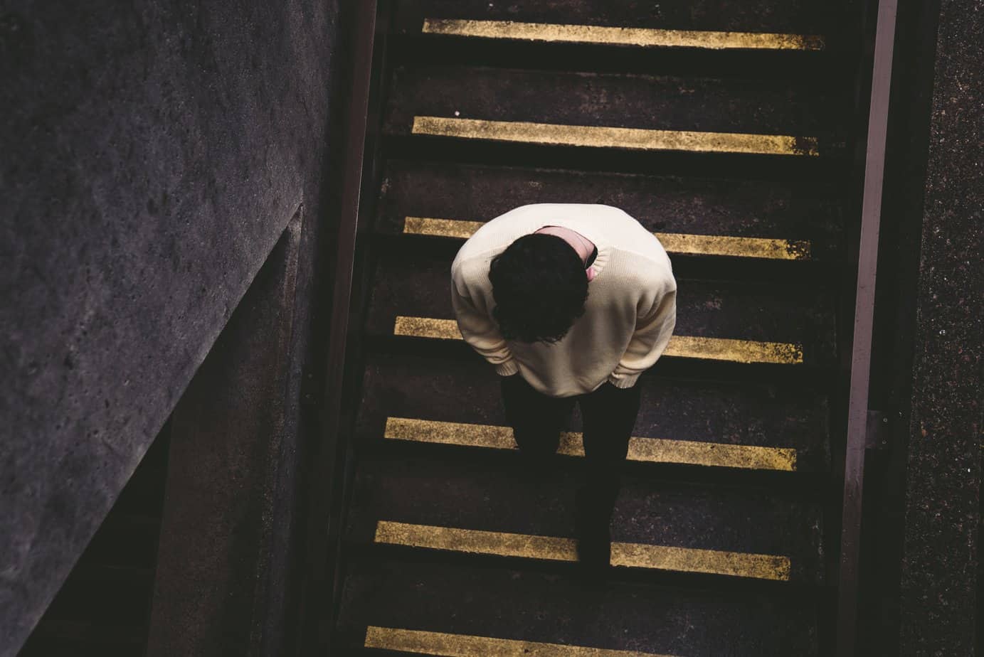 A man walks down a staircase. Dealing with heroin addiction