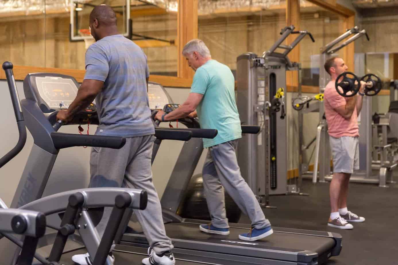 Two men on treadmills exercising to battle withdrawal symptoms at Mountainside rehab's gym