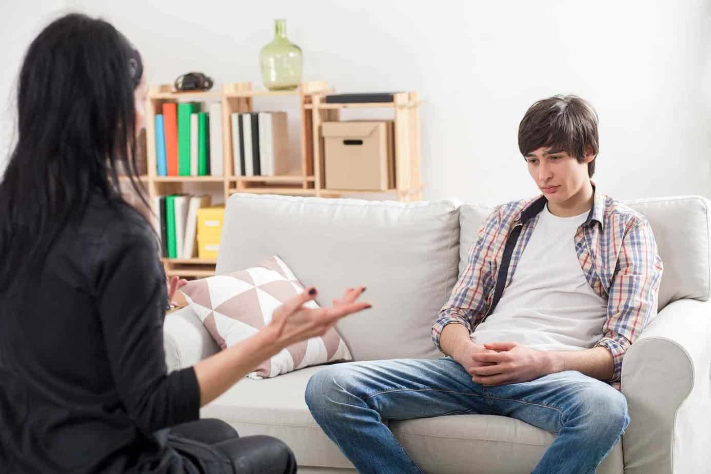 Female clinician and male teen in addiction treatment during an individual counseling session