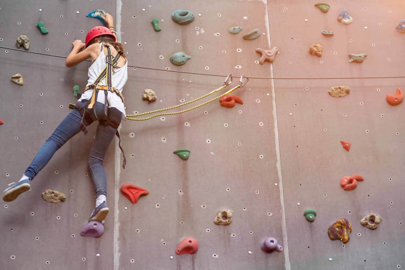 Woman rock climbing as part of adventure-based counseling at Mountainside in Canaan Connecticut