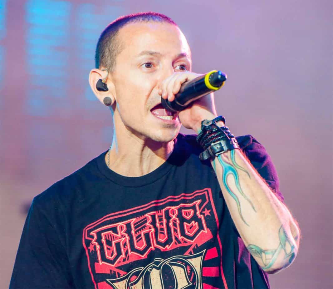 Linkin Park singer Chester Bennington singing with microphone in black tshirt