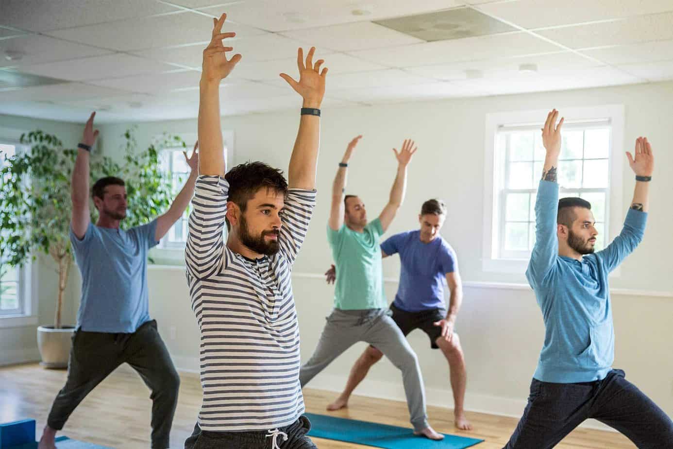 Mens group yoga class in the wellness studio at Mountainside addiction treatment center