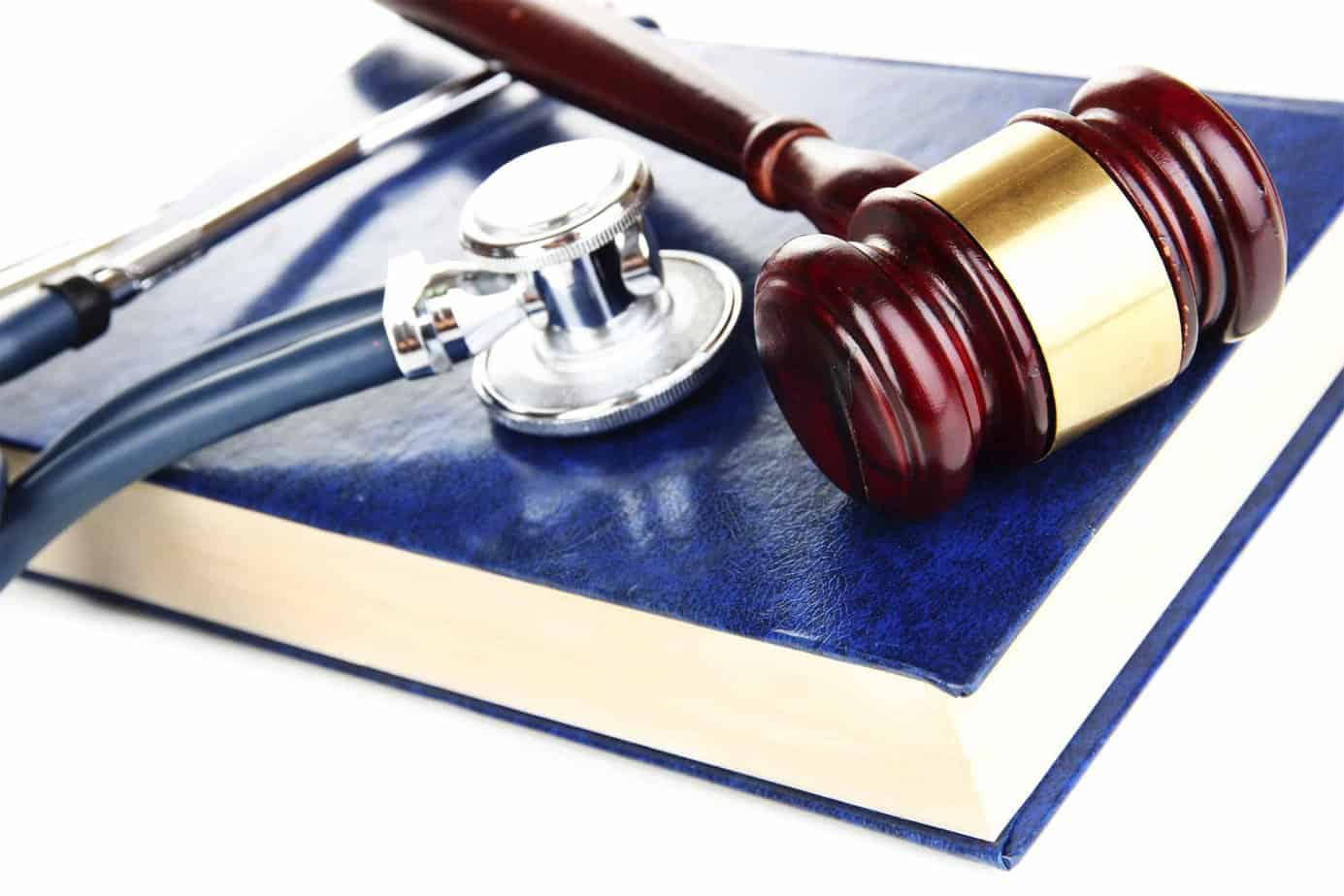 Gavel and stethoscope on blue book