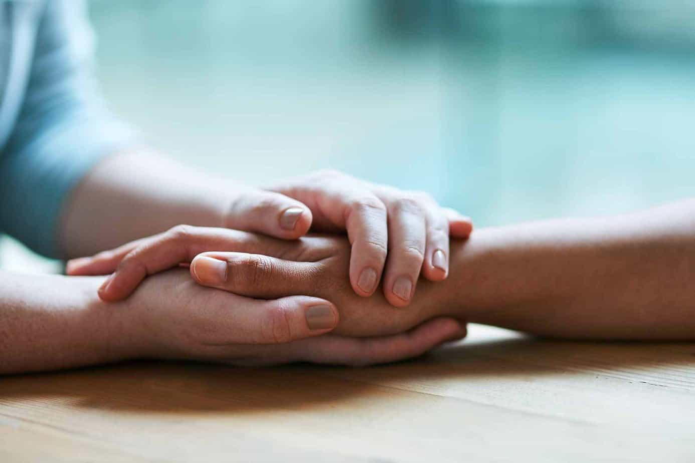 couple holding hands over a table