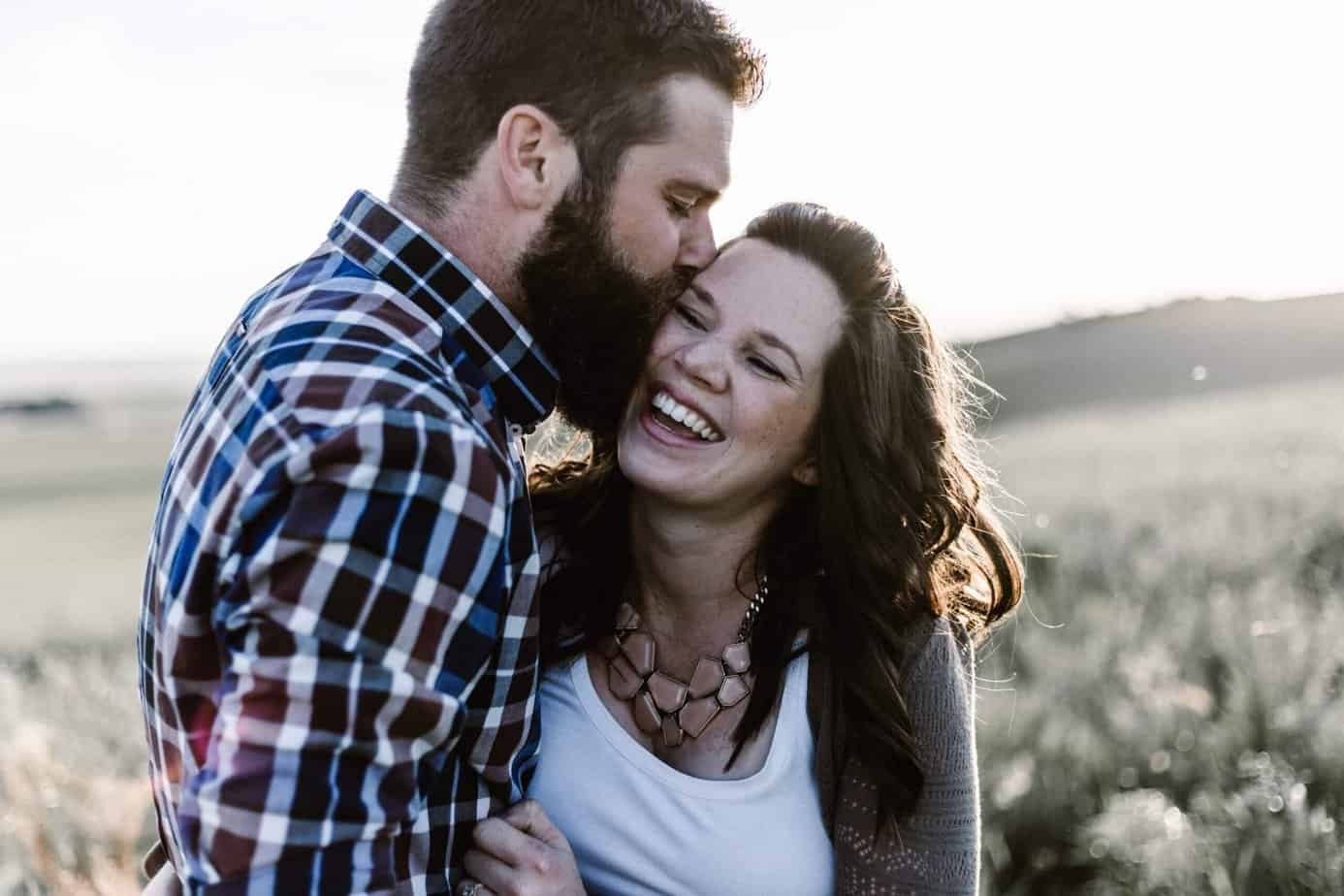 A man with a beard kissing a woman on the cheek; Addiction support group for spouses and partners.