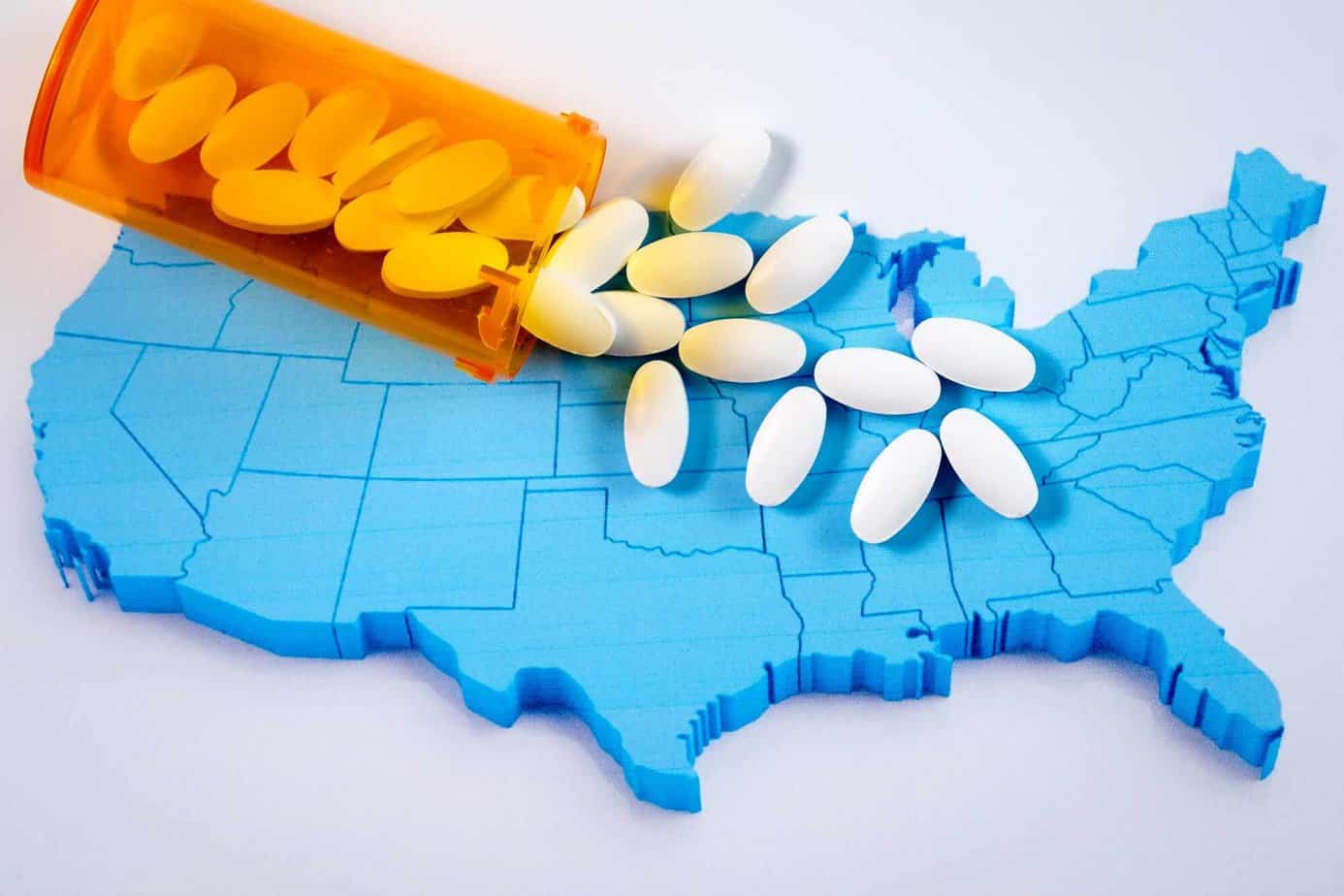 narcotics opioids spilled onto blue map of the United States