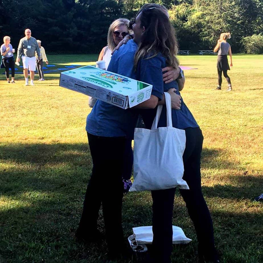 Woman hugging friend at Mountainside Treatment Center Canaan Alumni Retreat Event 2018