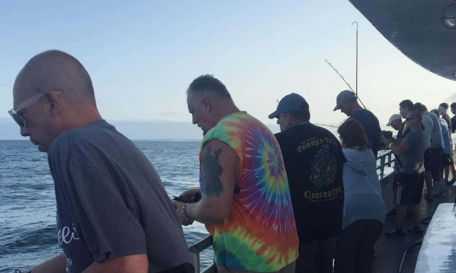 Men fishing at Mountainside Treatment Center Alumni Fishing Event