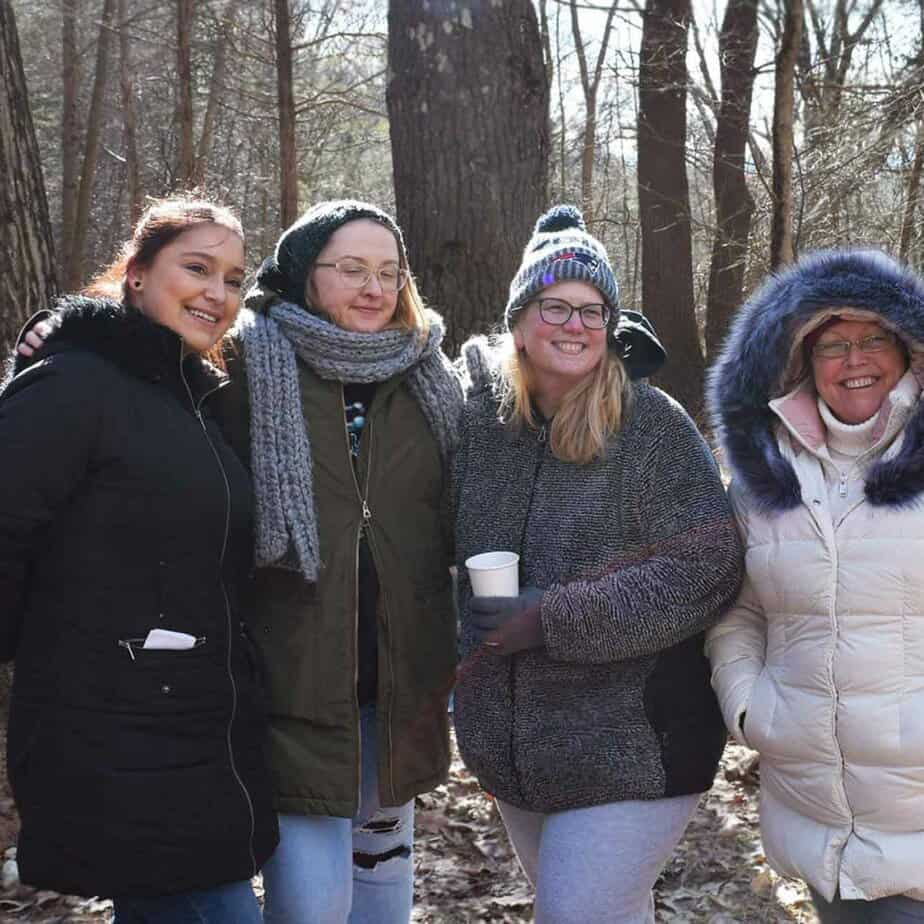 4 Women smiling outside at Mountainside Treatment Center Awaken the Senses Alumni Camping Event in Canaan