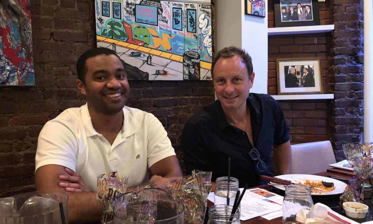 2 men smiling sitting at table at Mountainside Treatment Center Alumni Dinner & Roundtable