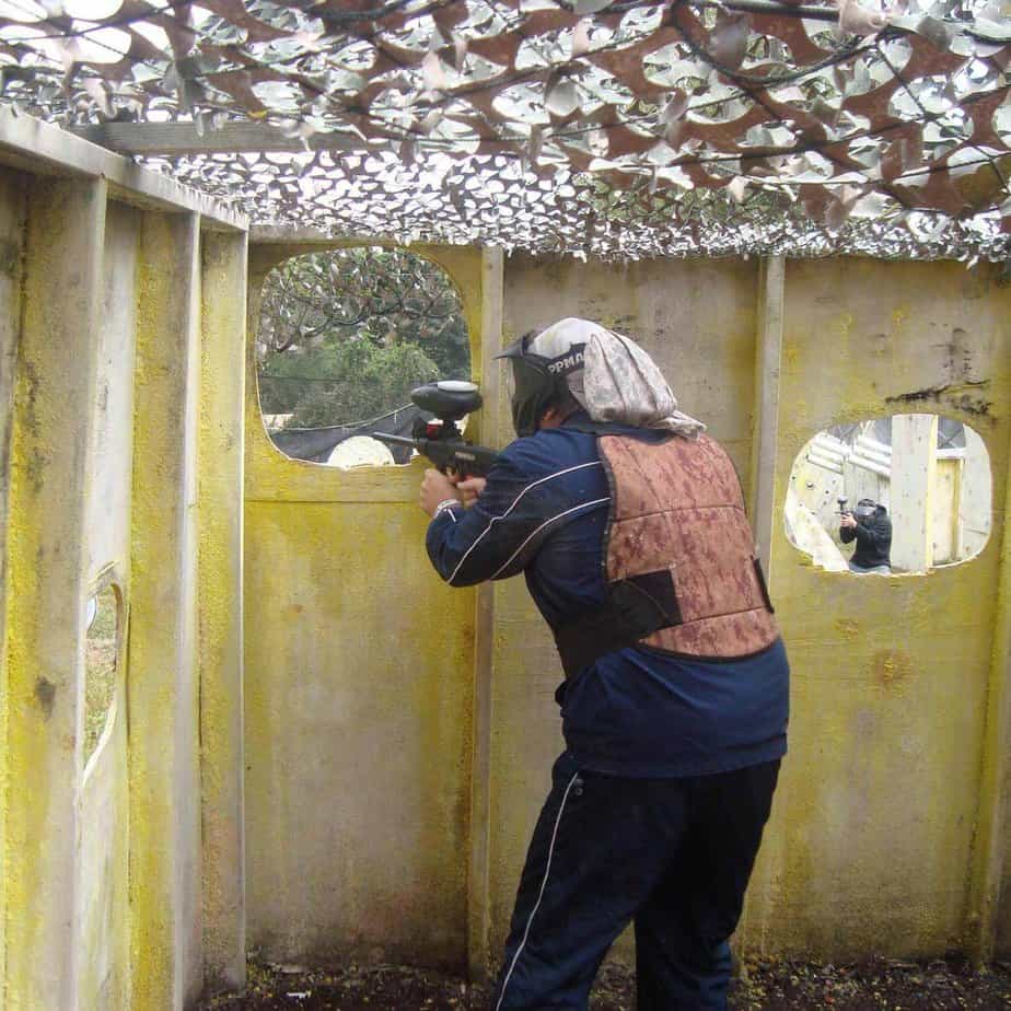 back of person playing paintball at Mountainside Treatment Center Alumni Paintball event in Hogan's Alley