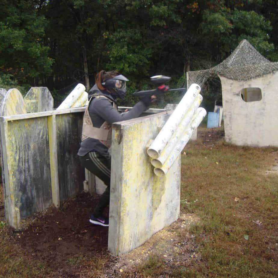 Woman in barricade at Mountainside Treatment Center Alumni Paintball event in Hogan's Alley