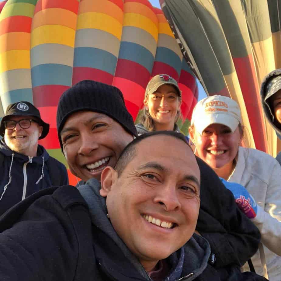 Group photo by hot air balloon at Mountainside Treatment Center Alumni Trip in Mexico City