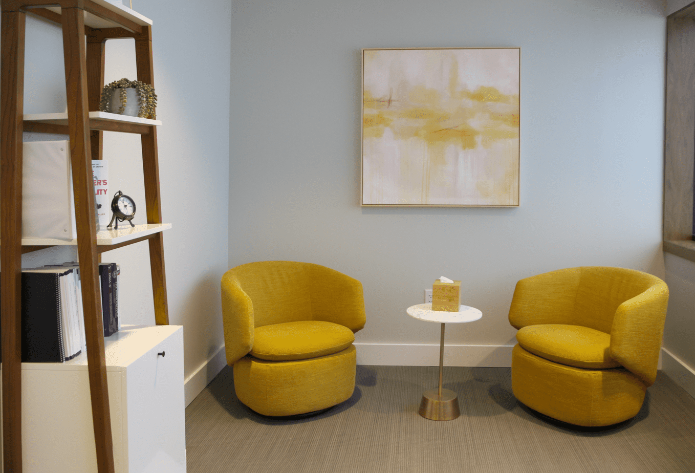 Individual counseling room with yellow chairs and aesthetic decor