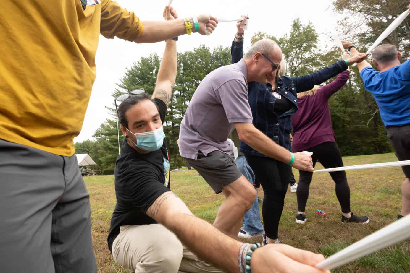 A group of happy people playing lawn games at Mountainside addiction treatment center