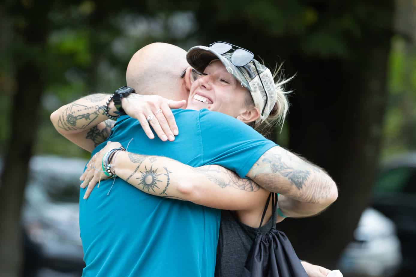 Two people hugging at the Mountainside addiction treatment center alumni reunion.