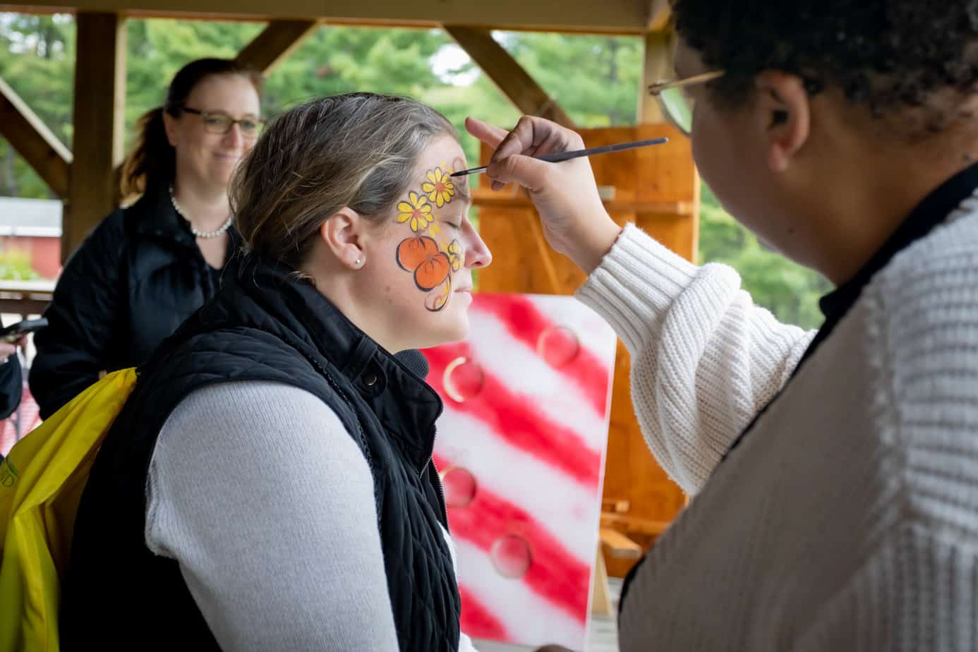 Photo of alumni face painting at the Mountainside addiction treatment center during the alumni reunion 2022.