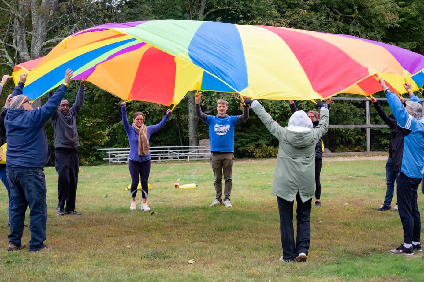 A group of people playing parachute lawn games at the Mountainside alumni reunion 2022.