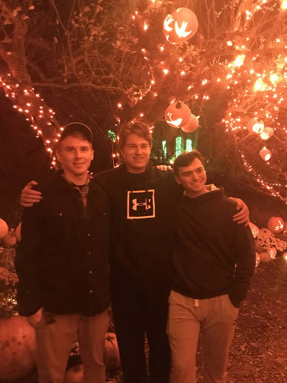 Three men smiling at Mountainside Treatment Center Extended Care Jack-O-Lantern Light Show Event October 2021