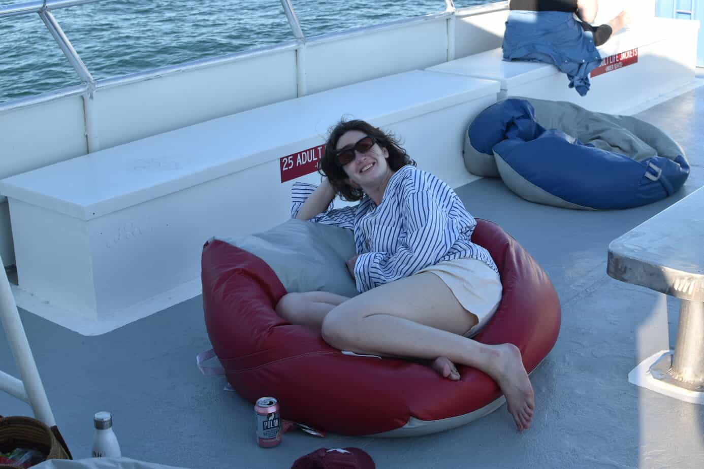 Woman relaxing on bean bag chair on boat at Mountainside Treatment Center Extended Care Fishing Event September 2022
