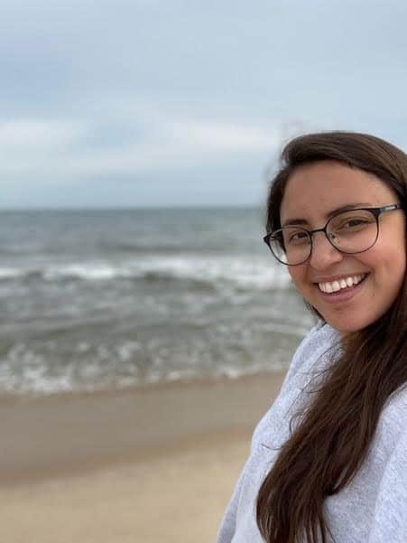 woman in glasses smiling at beach