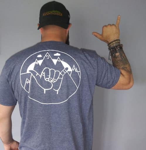 man wearing shirt embossed with hand symbol