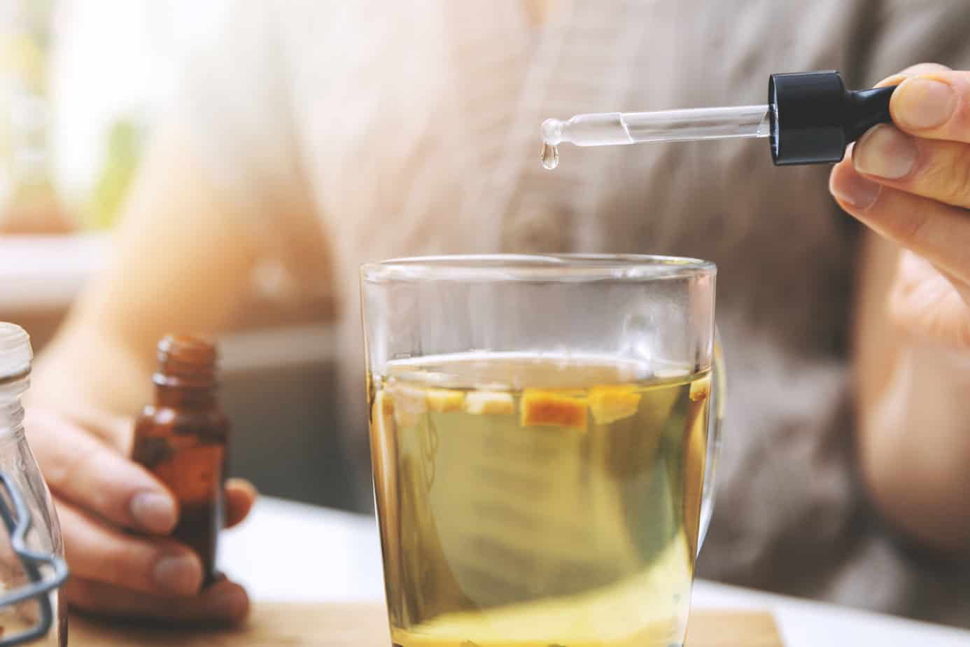 cbd being dropped into herbal tea