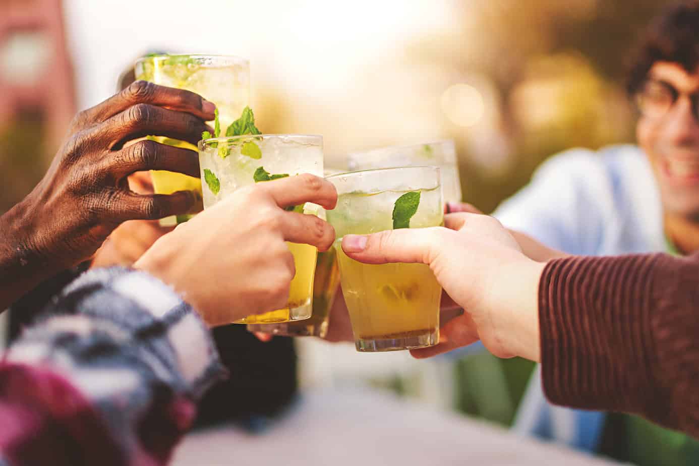 group of friends toast with non-alcoholic drinks