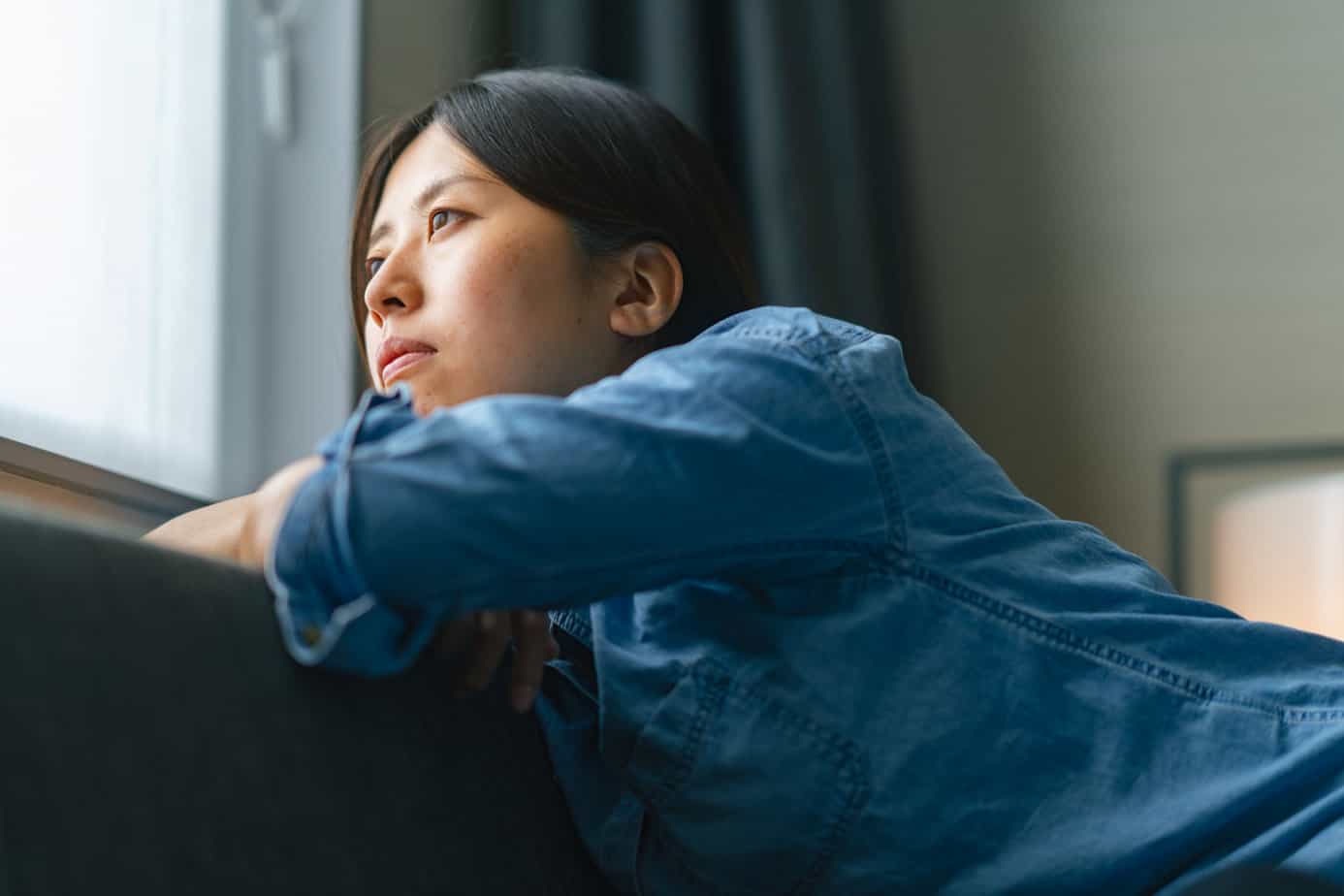 woman struggling with alcohol cravings looking out the window